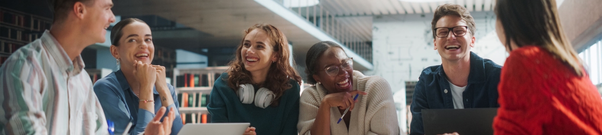 Group of diverse college students smiling while meeting.