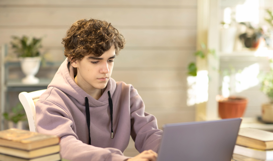 High school student using his laptop.