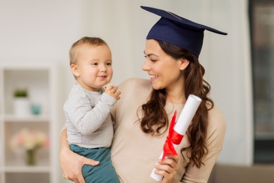 Recently college graduate mother holding her baby.